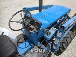 New Holland 1920 Tractor with Loader, Backhoe and 4 ft. Rotary Cutter